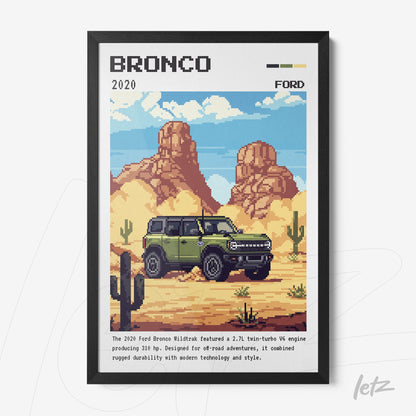 pixel art wall decor of the 2020 Ford Bronco in black frame, desert scene with mountains in the background and cacti