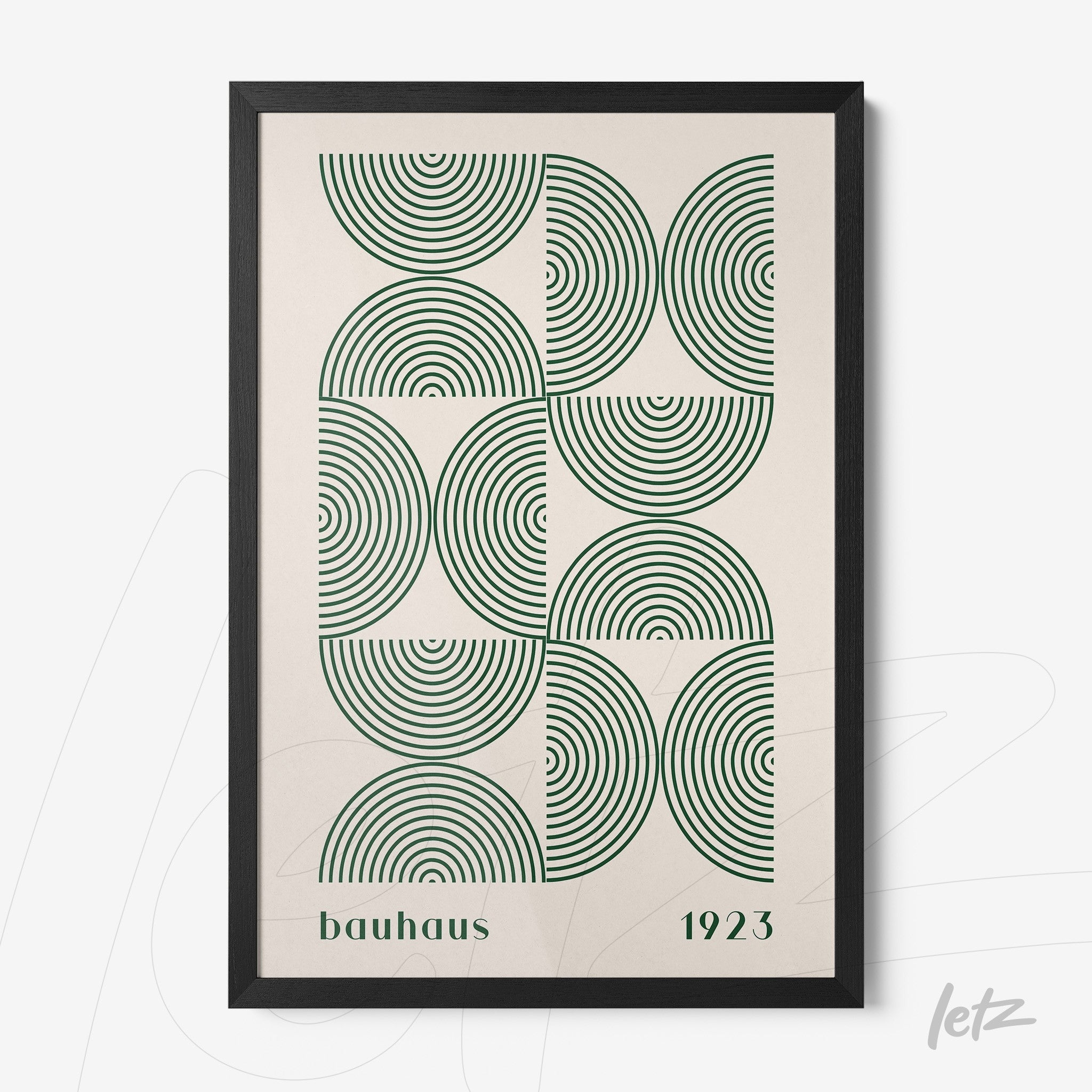 framed wall art with bauhaus style geometric design of green concentric circles and black frame