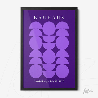 framed wall art featuring geometric shapes in purple hues, with the text 'bauhaus' at the top and 'ausstellung - july 19, 1923' at the bottom, in a black frame