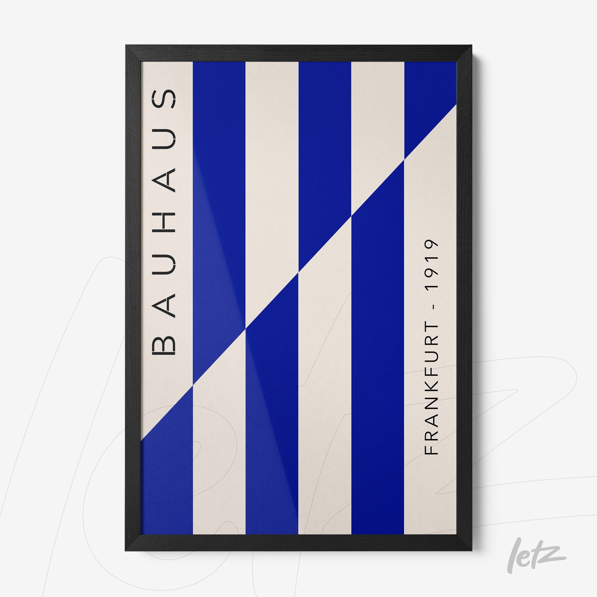 poster print featuring geometric bauhaus style design in blue and white tones, black frame displayed on white wall
