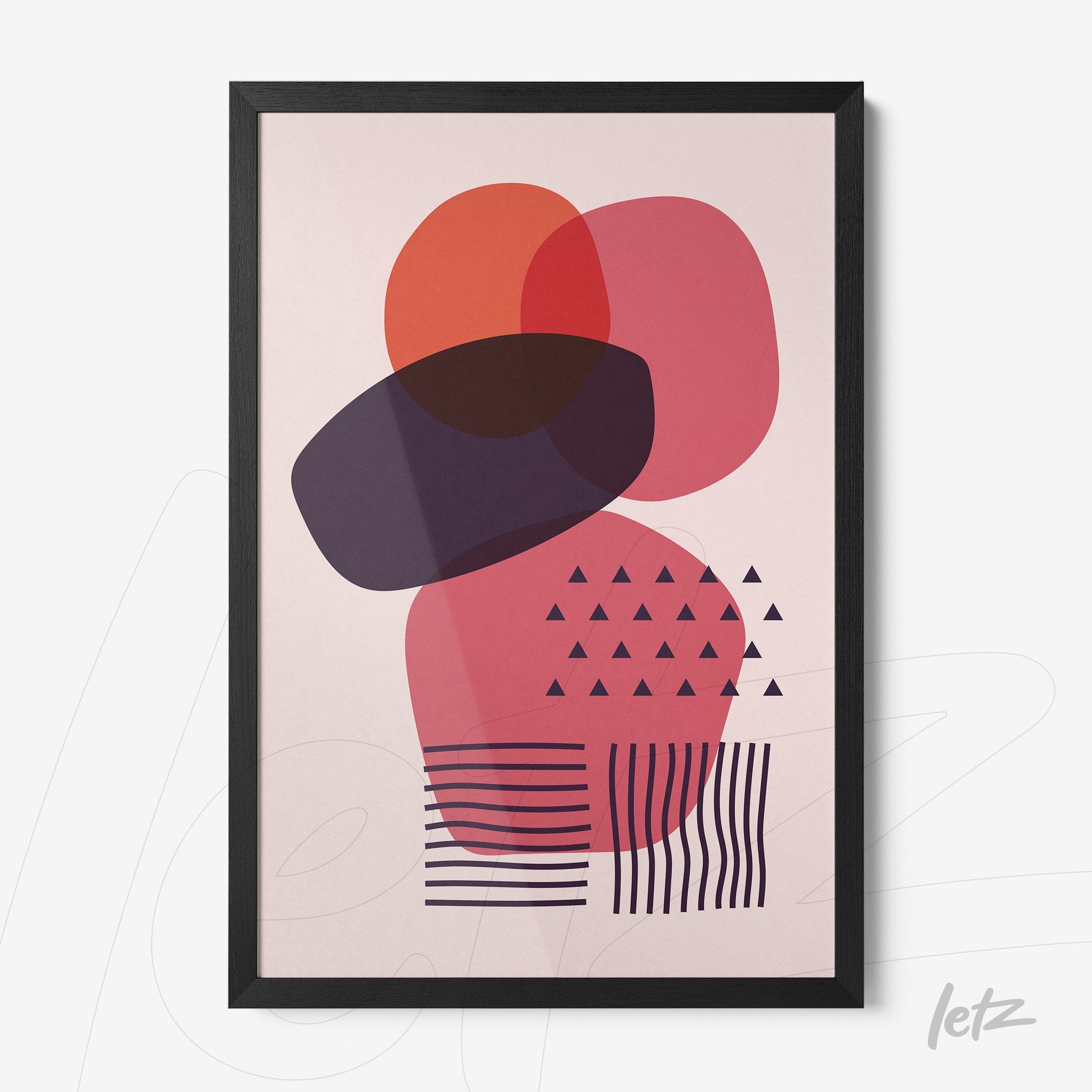 black framed abstract art with geometric shapes in red and purple hues