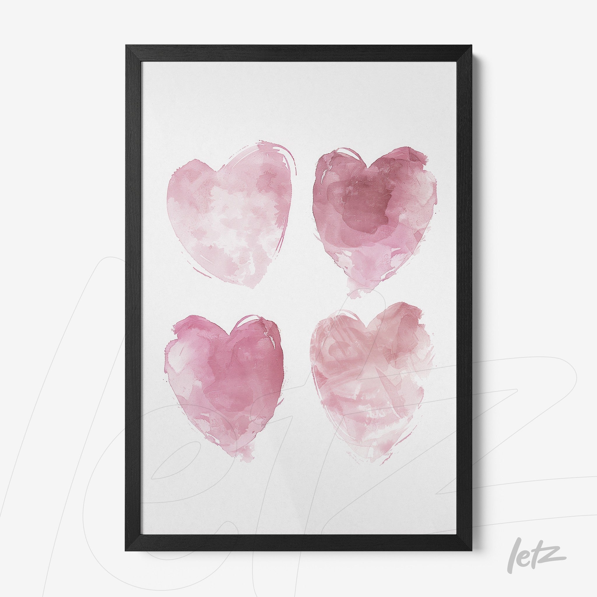 framed artwork featuring four pink watercolor hearts on a white background with a black frame