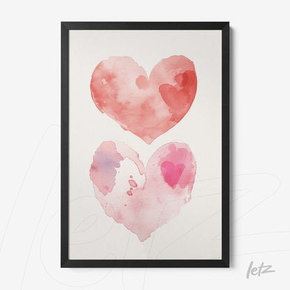 framed watercolor art depicting two hearts in shades of pink and red with a black frame