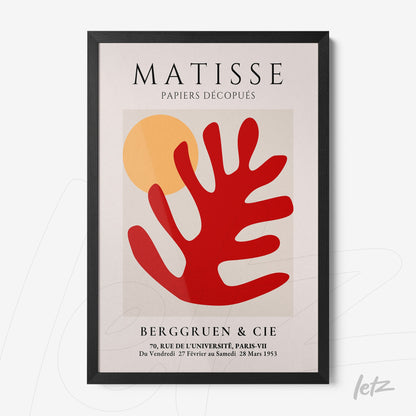 framed artwork featuring modern art in vibrant colors, showcasing geometric shapes and a stylized red leaf on a light background, black frame