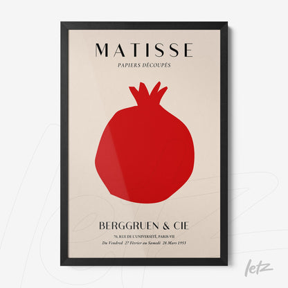 framed wall art featuring a minimalist design of a red pomegranate on a light background