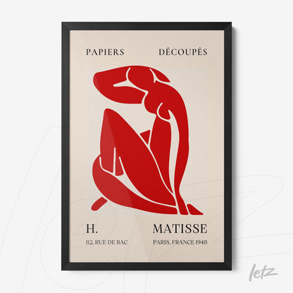 framed modern art of a female figure in red cutouts on a cream background with a black frame