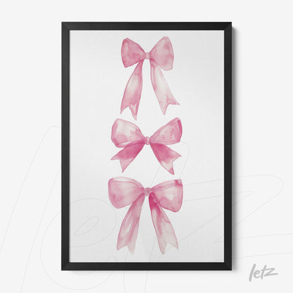 framed artwork featuring three pink watercolor bows with a black frame