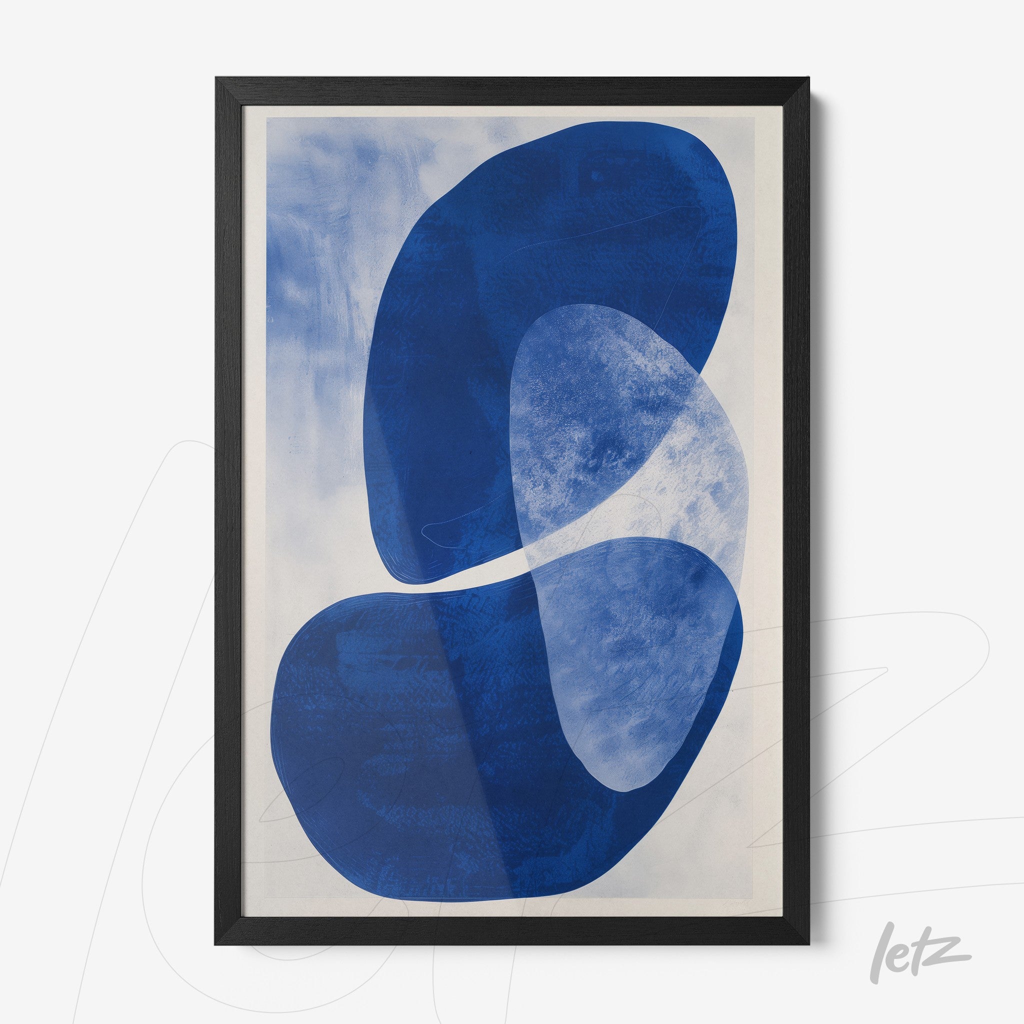 framed abstract art piece in shades of blue with black frame