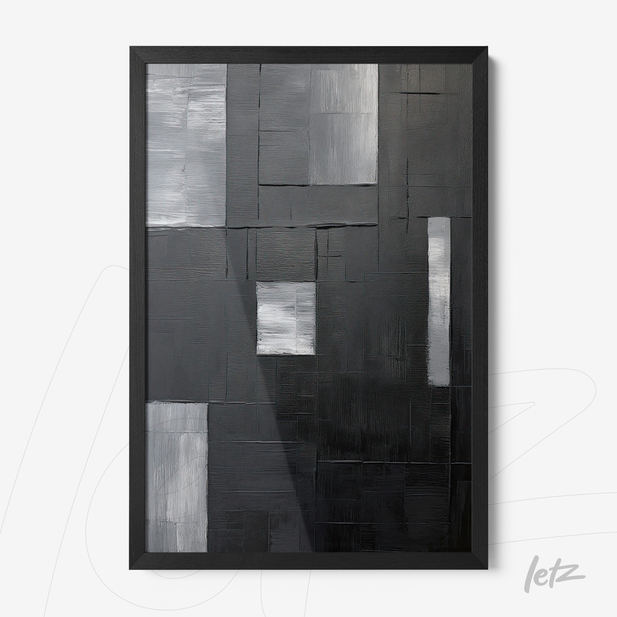 abstract wall art in shades of black and gray featuring textured brushstrokes and a black frame