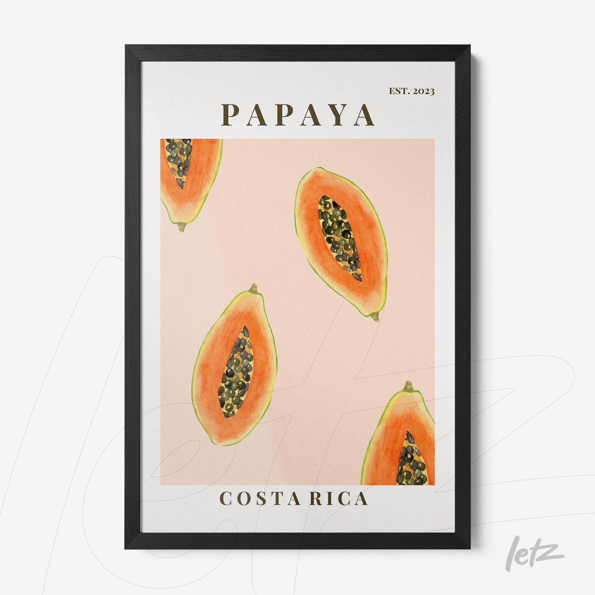 framed wall art featuring sliced papayas on a pink background