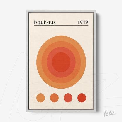 canvas print with concentric circles in orange shades with silver frame, bauhaus style