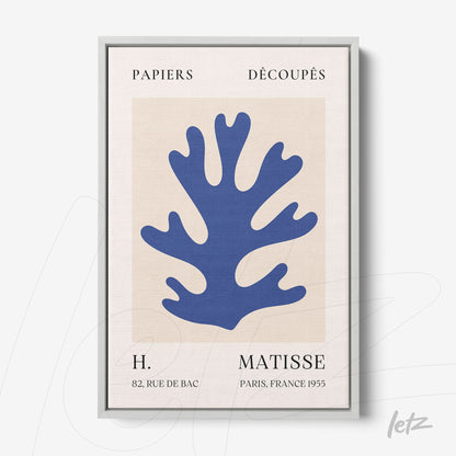 framed abstract artwork in blue tones depicting a stylized coral, with silver frame