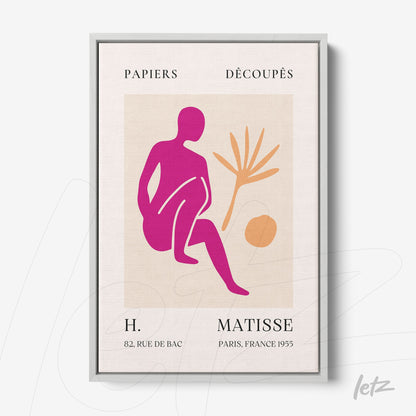 modern wall art featuring a pink and orange stylized figure of a seated person and a plant on a light background with a silver frame