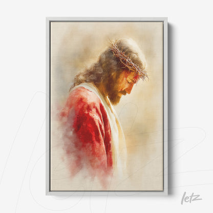 framed portrait of Jesus wearing a crown of thorns with a soft light-colored background and silver frame