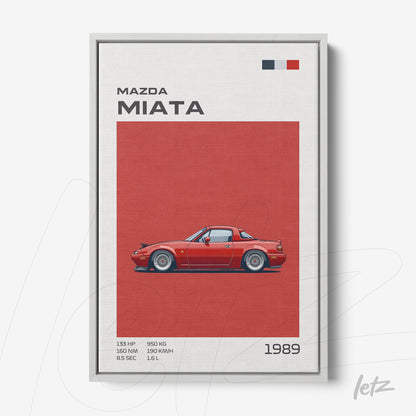 framed art of a 1989 Mazda Miata illustration with silver frame, red background, and detailed information alongside