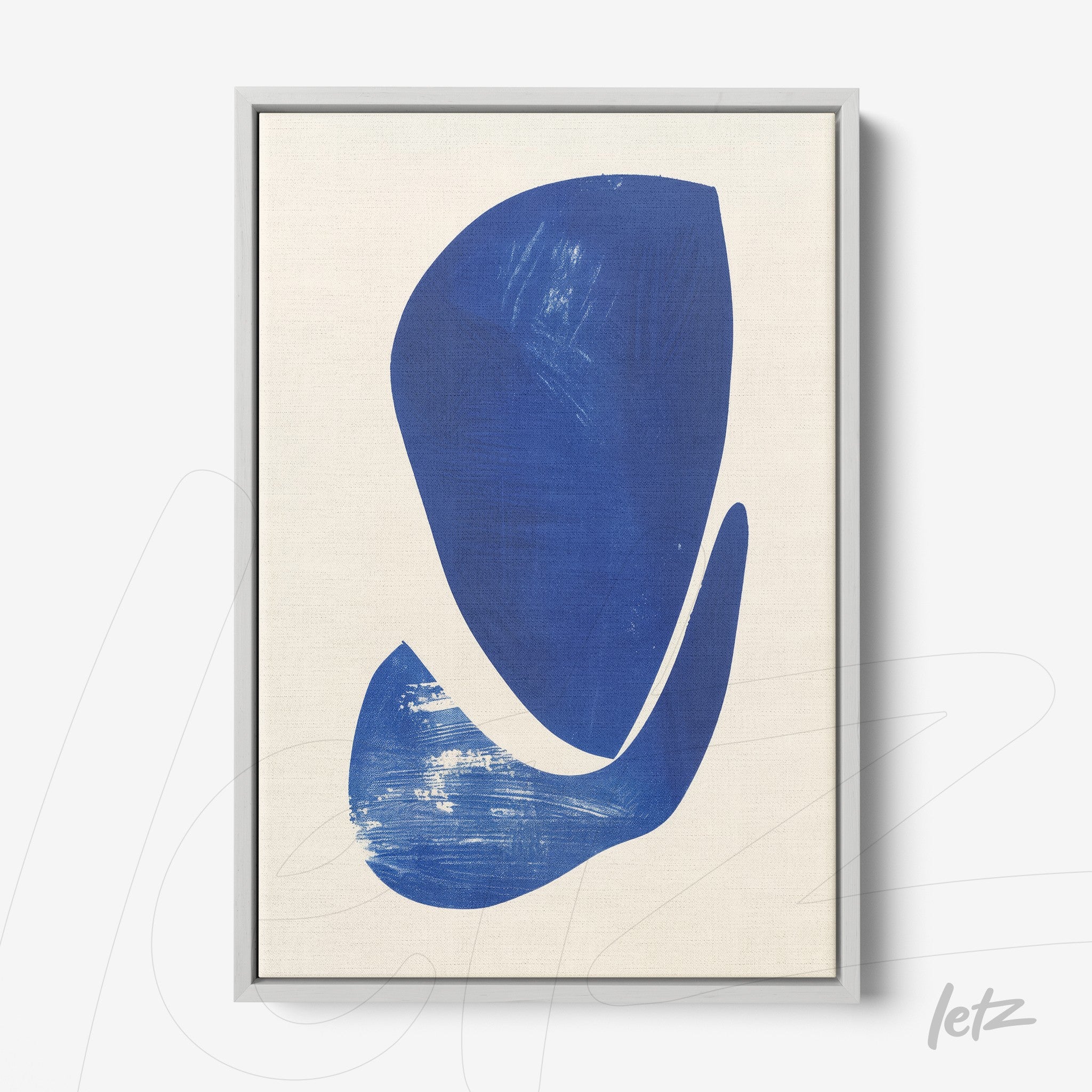 framed wall art featuring abstract shapes in shades of blue on light background with silver frame