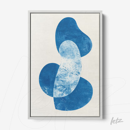 framed wall art featuring abstract blue shapes on light background