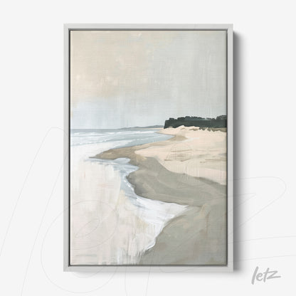 framed artwork depicting a beach landscape with soft waves and sandy shore in white frame
