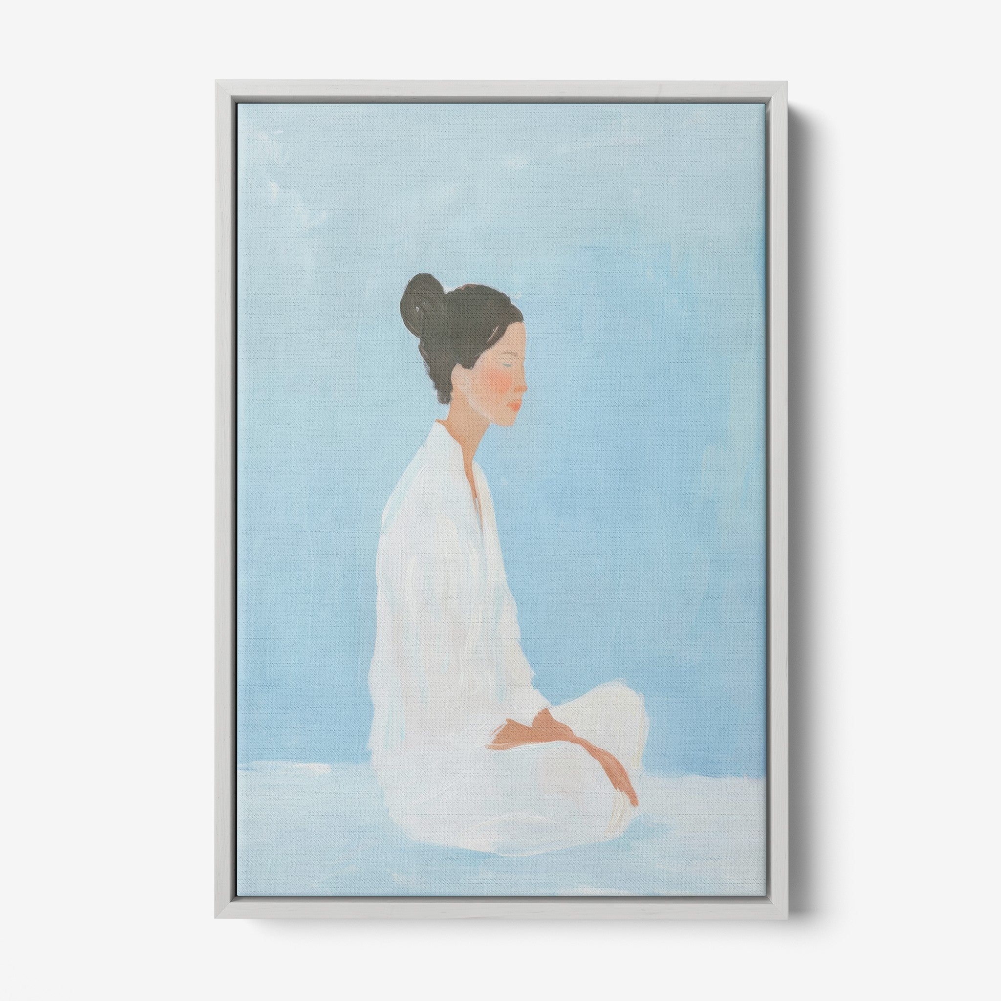 canvas art featuring a portrait of a meditative woman against a light blue background with a gray frame