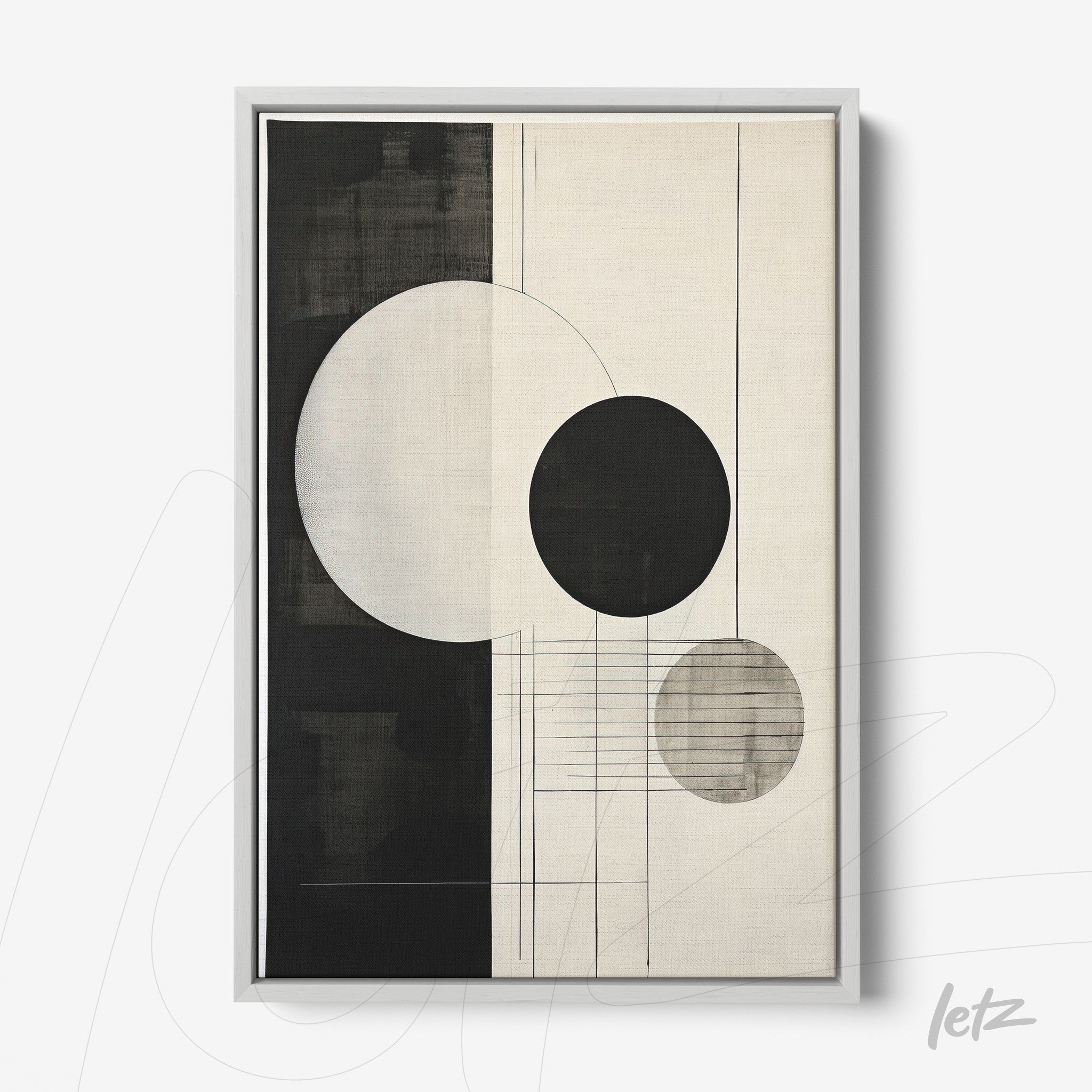 abstract wall art in black and white featuring circular and linear geometric shapes in a silver frame