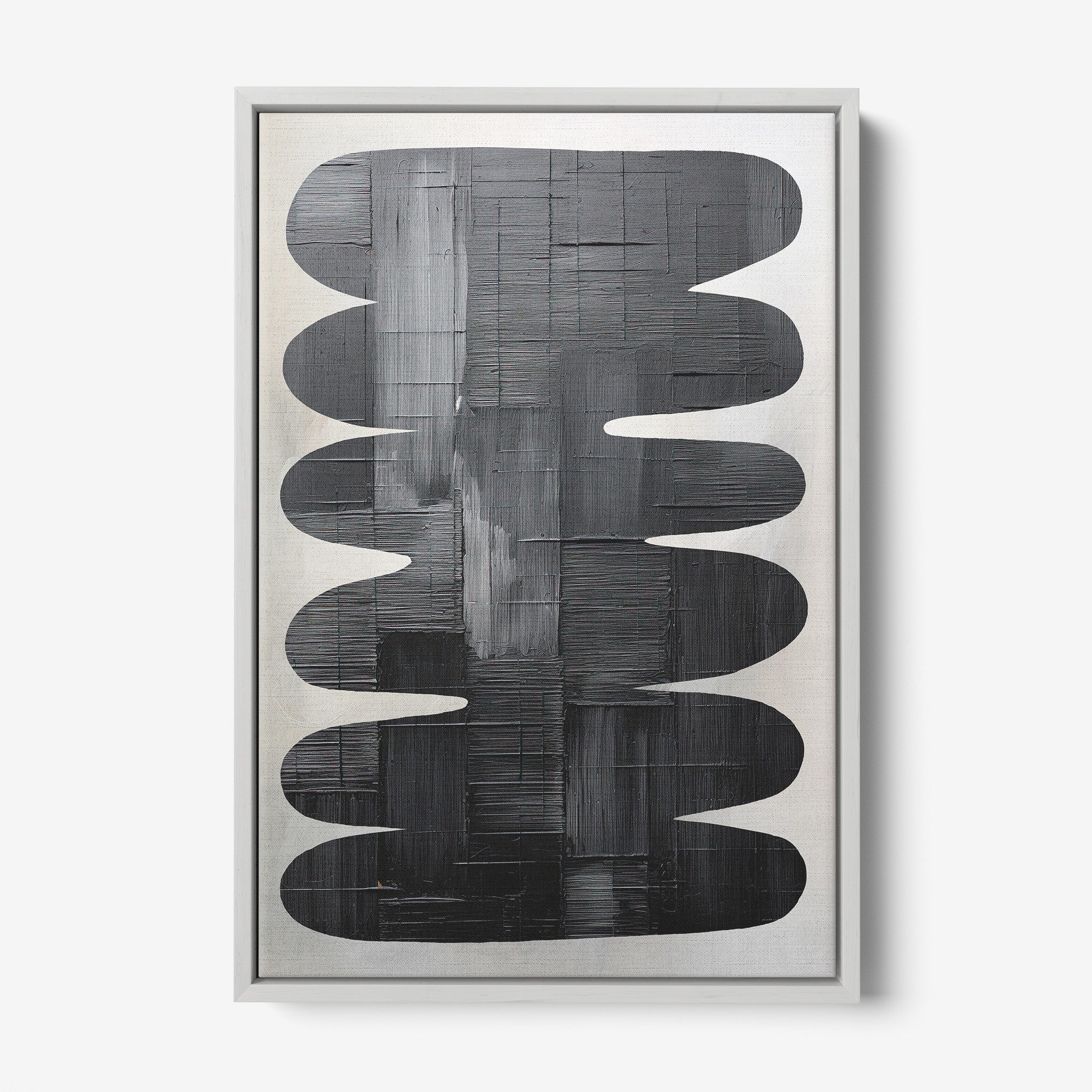 framed artwork featuring abstract black shapes on a light background with silver frame