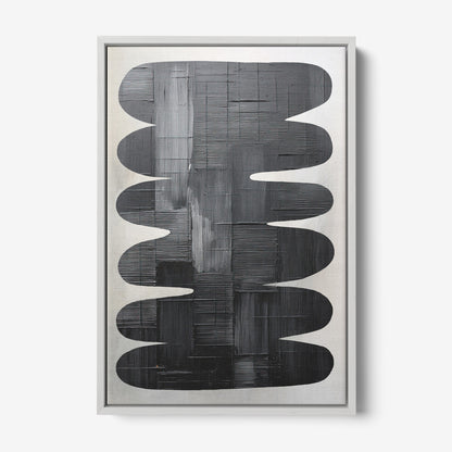 framed artwork featuring abstract black shapes on a light background with silver frame