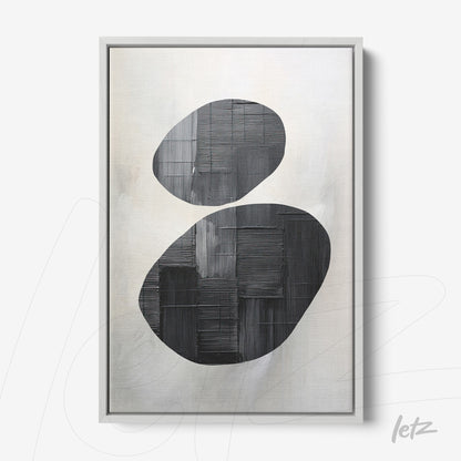 abstract wall art featuring black ovals on a light background with a silver frame