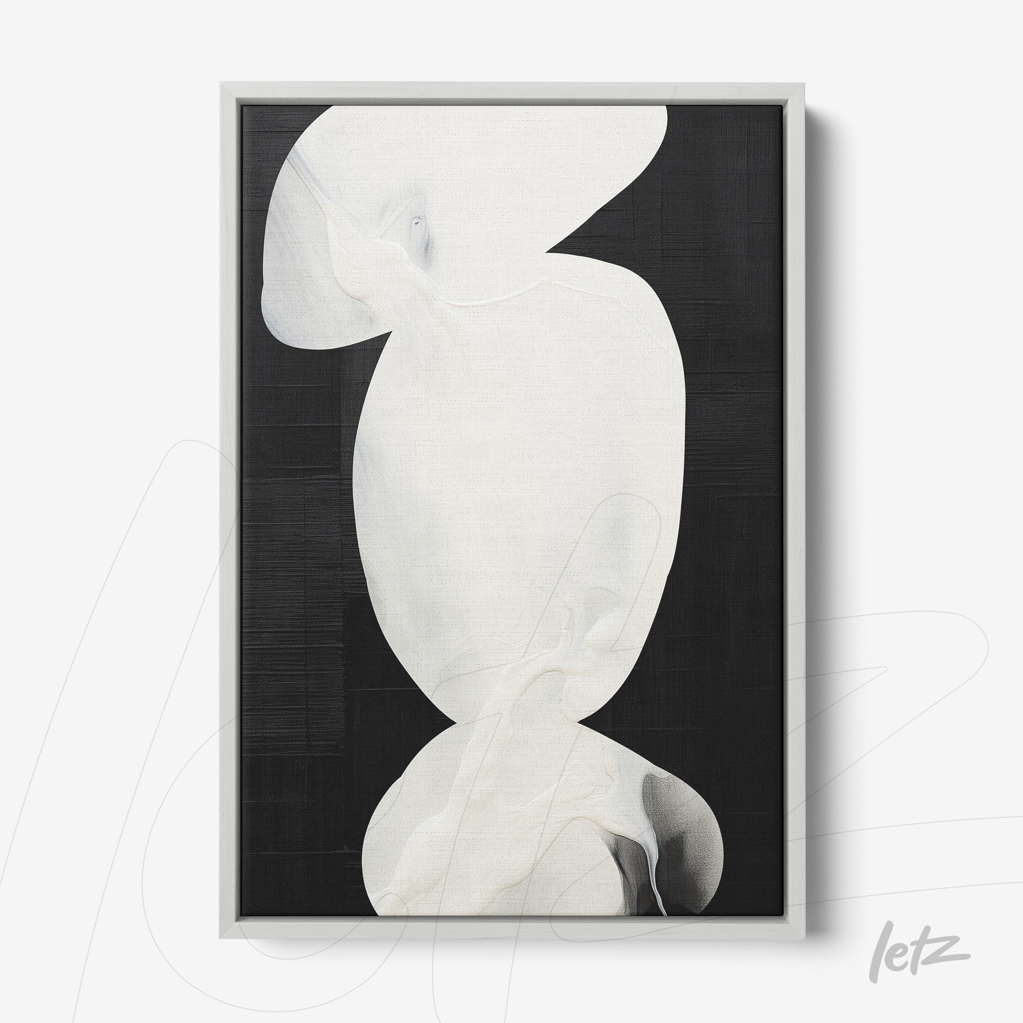 abstract wall art featuring white shapes on a black background in a light frame