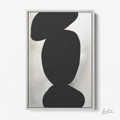 framed abstract art with black shapes on a light background and a silver frame