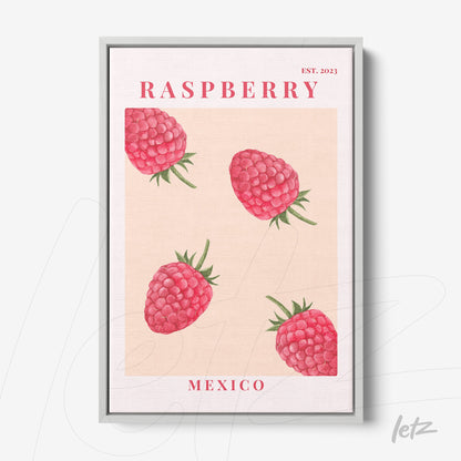 framed wall art featuring raspberries on a light background with a silver frame