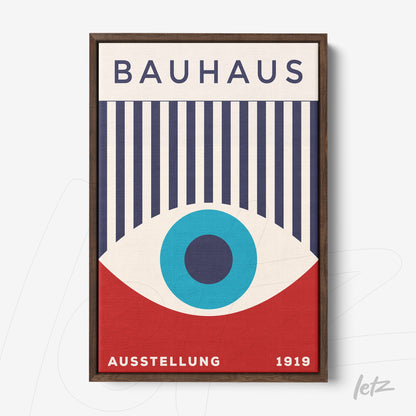 poster print featuring minimalist Bauhaus style art with a centered blue eye, navy vertical lines, and red background, framed in dark wood