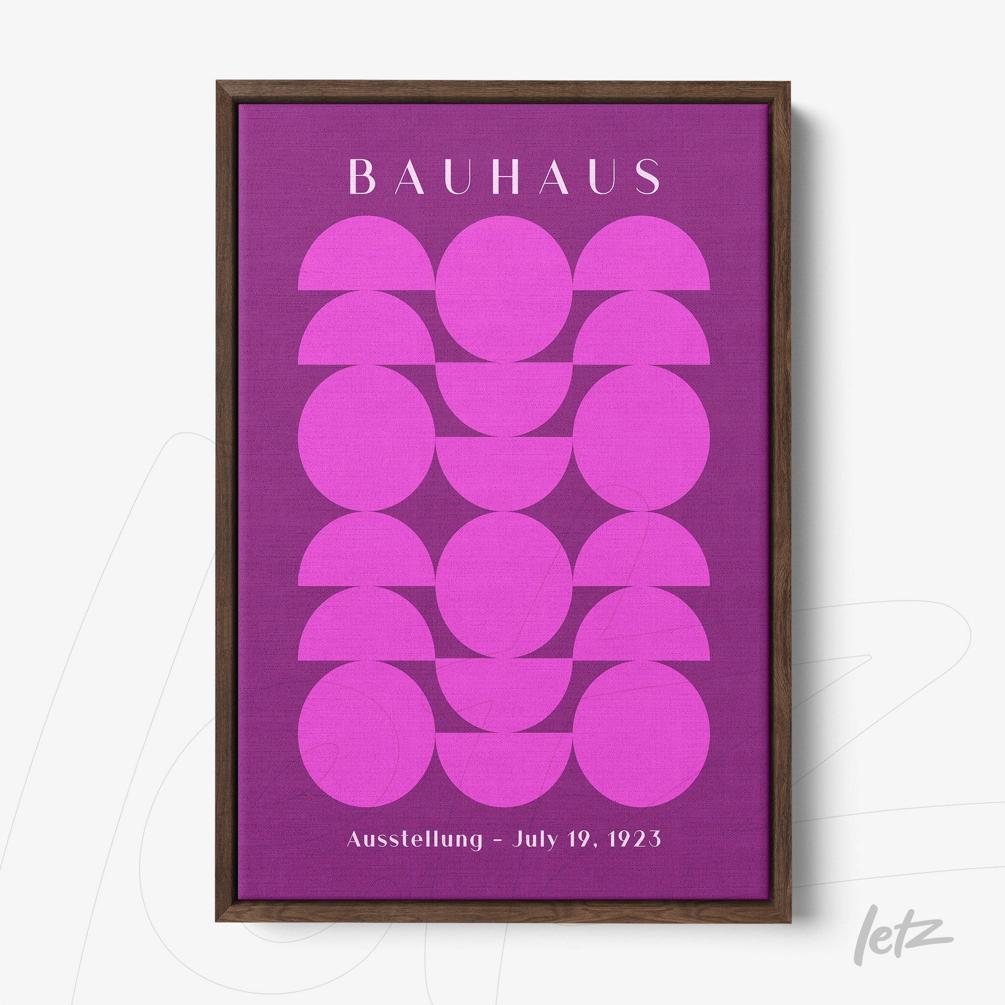 poster print with geometric design in pink and purple shades framed in dark wood