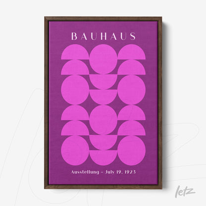poster print with geometric design in pink and purple shades framed in dark wood