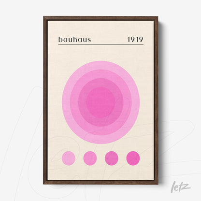 minimalist geometric wall art with shades of pink, dark brown frame, displayed on a white wall