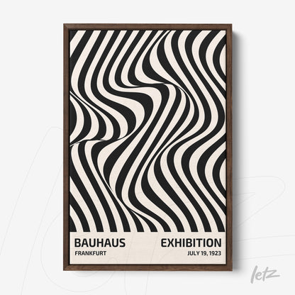 framed poster in black and white op art style featuring text about Bauhaus exhibition with dark wood frame