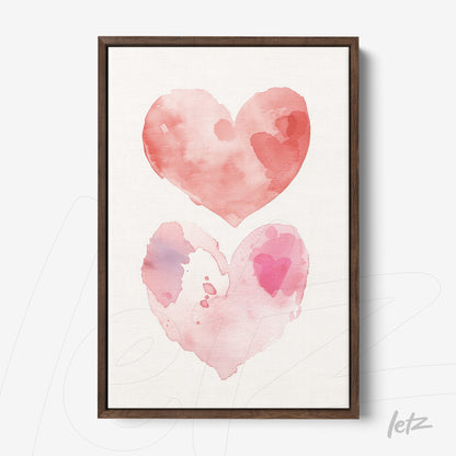 framed watercolor art featuring two hearts in shades of pink with a dark wooden frame