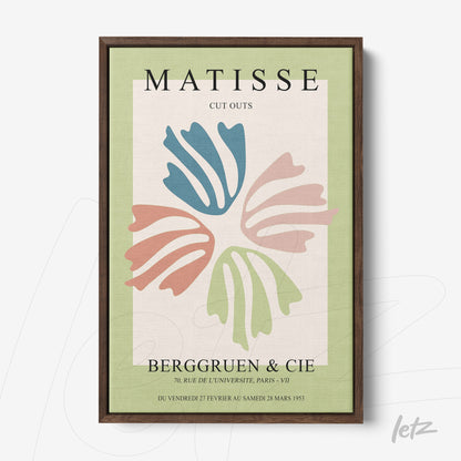 framed wall art featuring matisse cut outs with a brown frame, green background and colorful shapes in blue, pink and cream