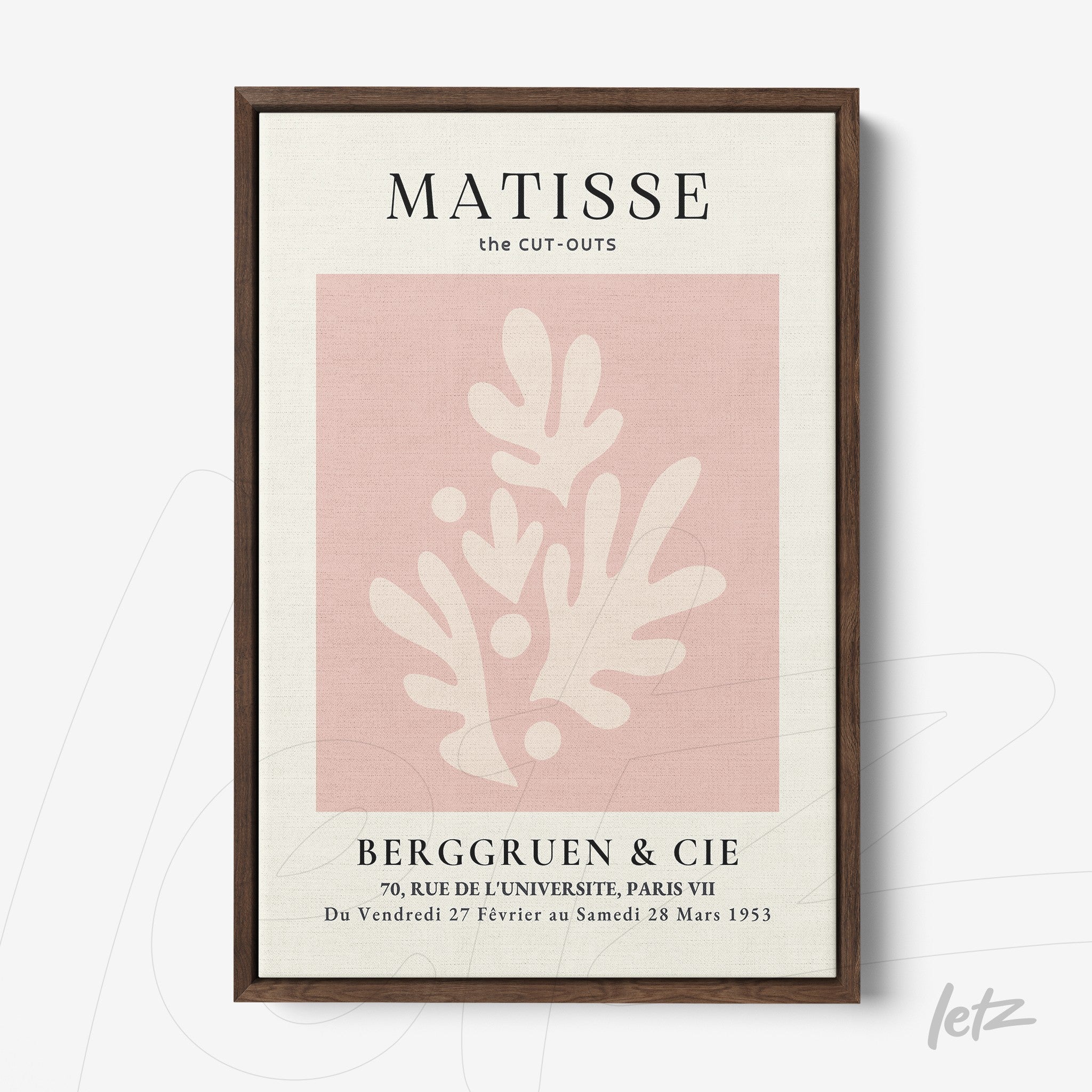 framed art print featuring pink cut-out shapes on a light background with dark frame