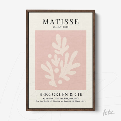 framed art print featuring pink cut-out shapes on a light background with dark frame