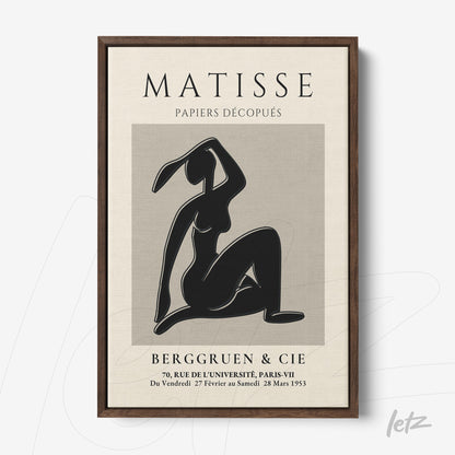 framed art piece featuring a modern black figure in a sitting pose against a beige background