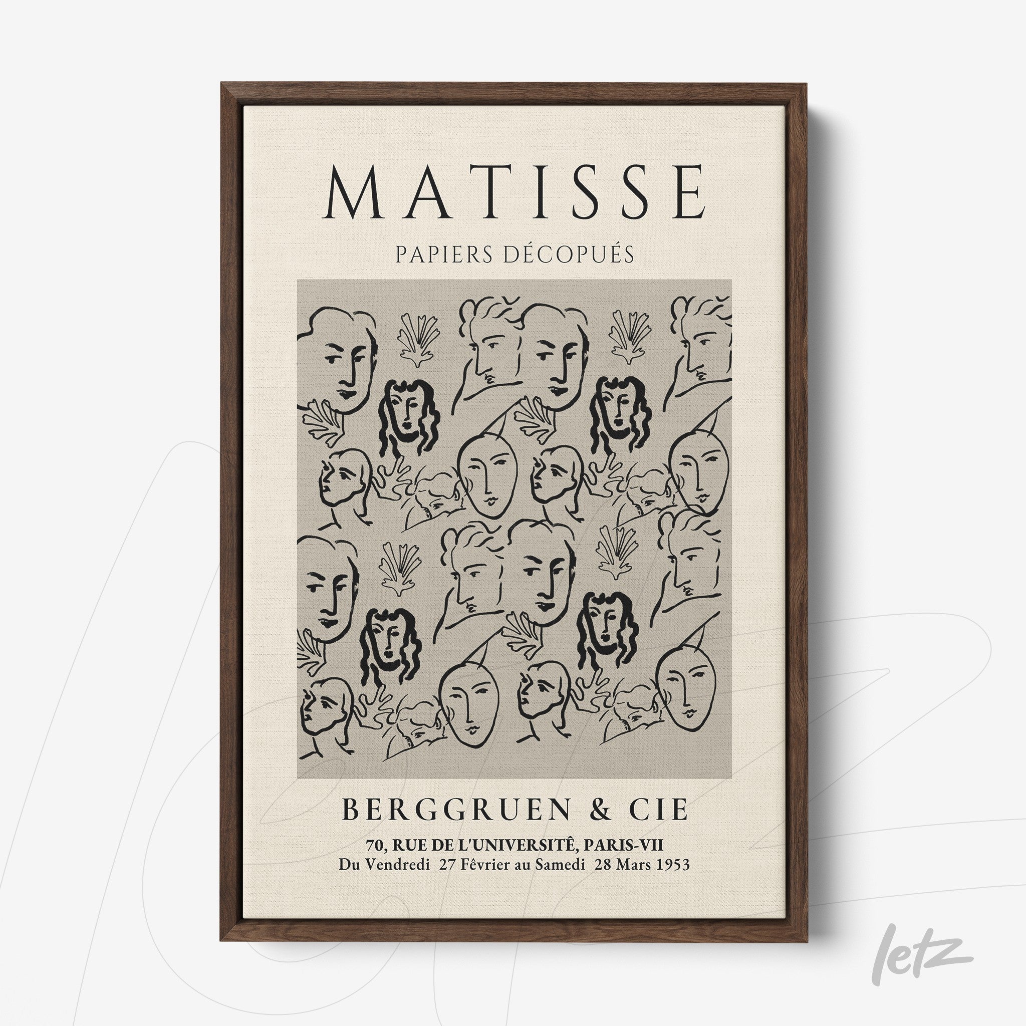 framed wall art featuring modern style black and white faces against a light background with dark wooden frame