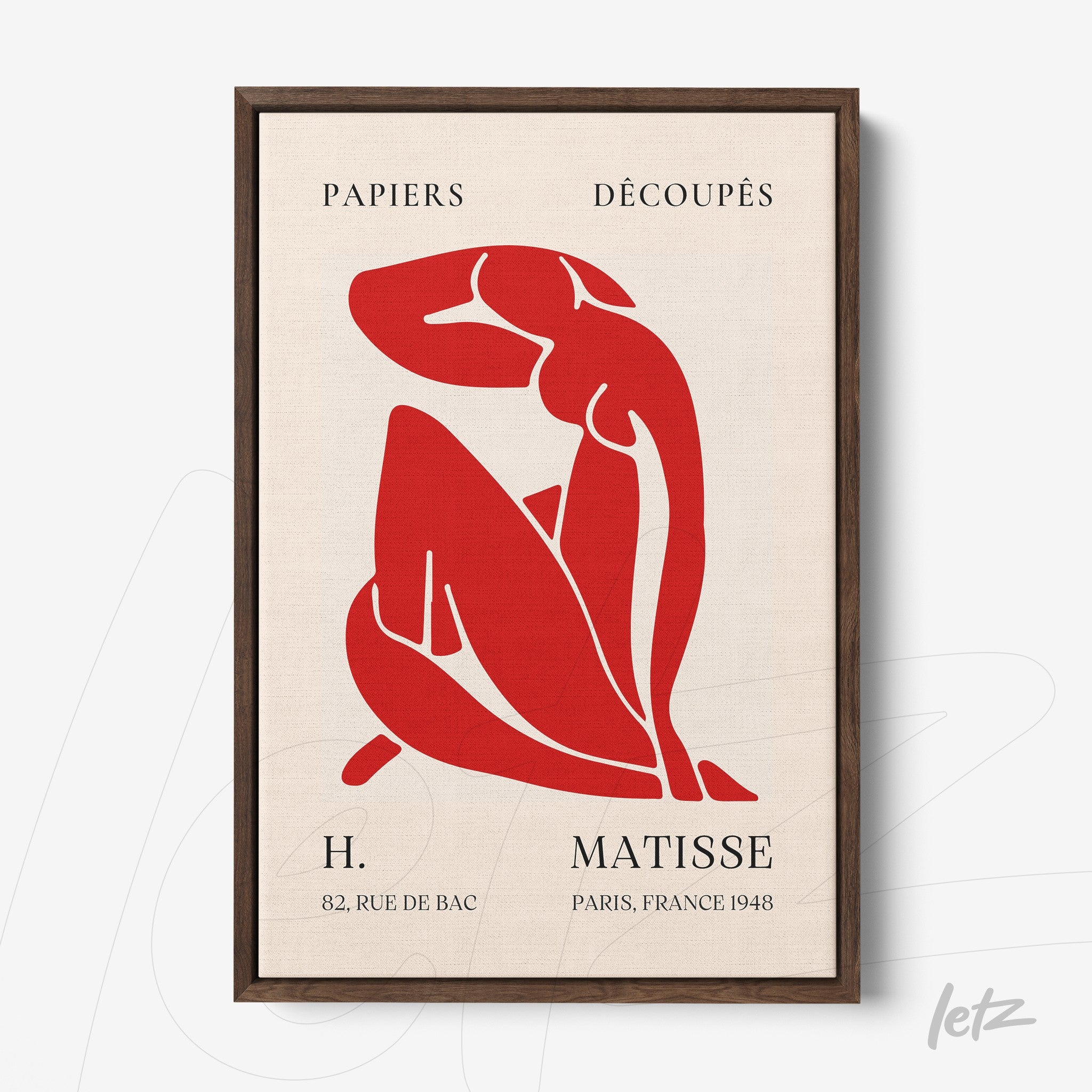 framed wall art featuring abstract red figure of a woman with dark wooden frame and light background