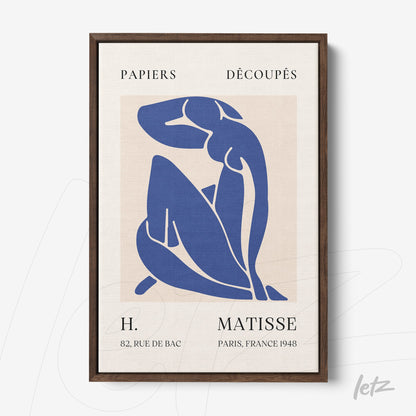 framed artwork featuring a cut-out style blue figure on a light background with dark wooden frame