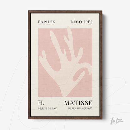 framed artwork by artist henri matisse featuring a hand silhouette on a light pink background with a dark frame