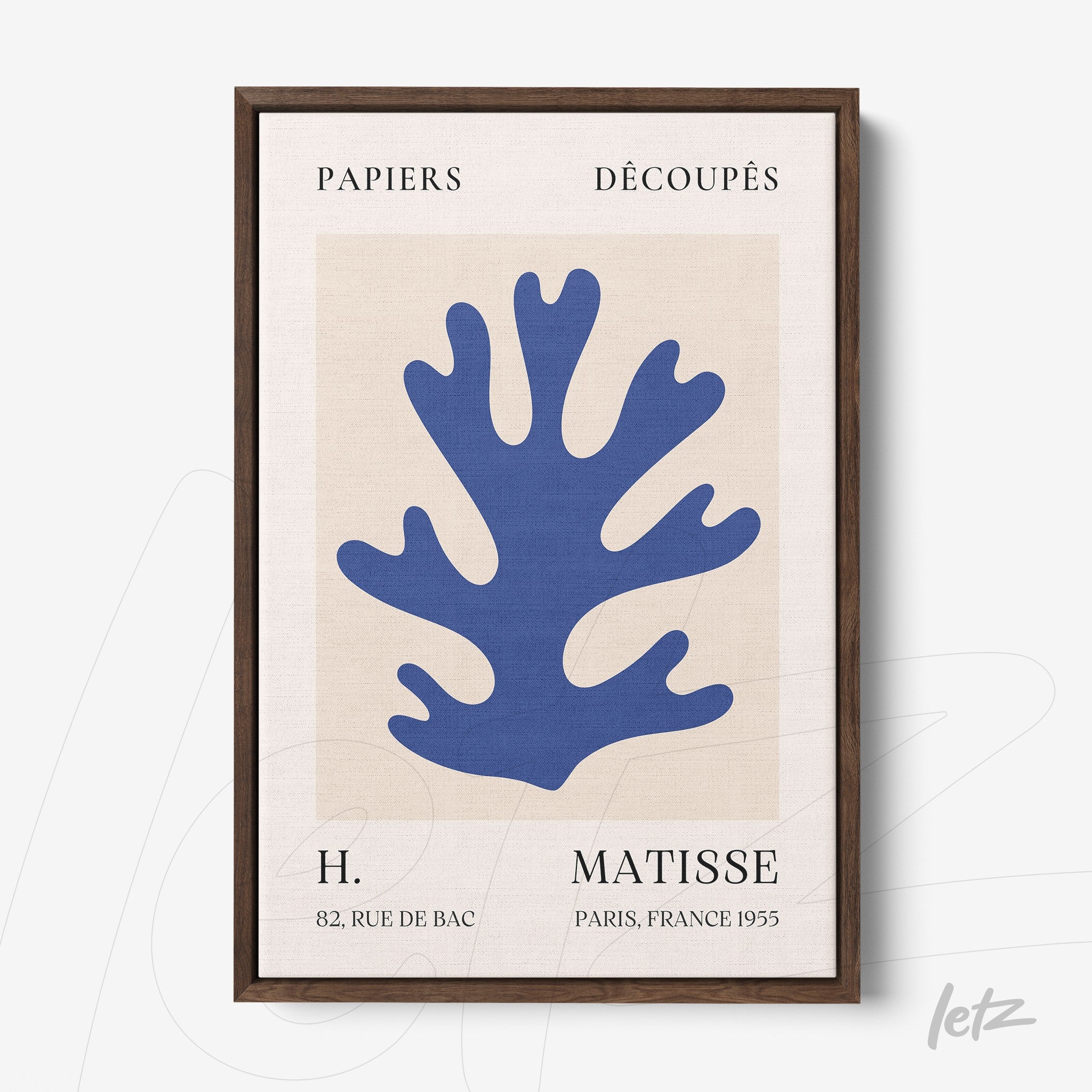 framed modern art print in blue and beige featuring a cutout design of coral shape with dark wood frame