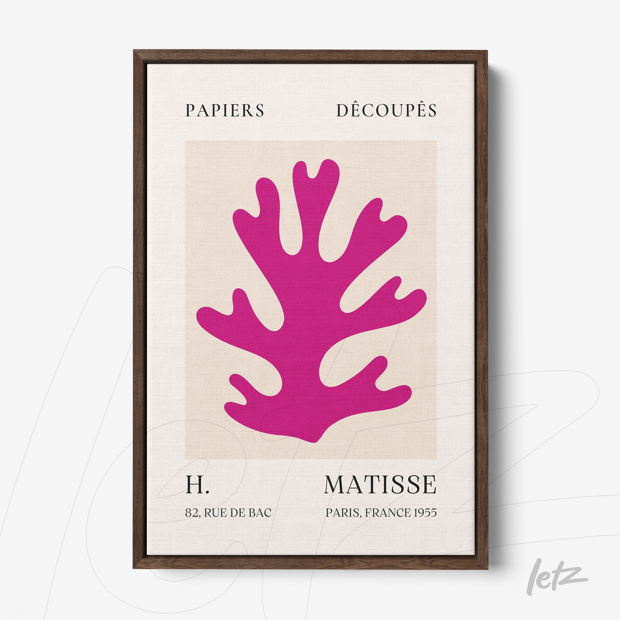 framed wall art featuring a vibrant pink cut paper coral design with a dark wood frame