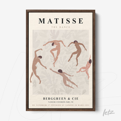 decorative framed art featuring stylized dancers in earthy tones against a light background with a dark wooden frame
