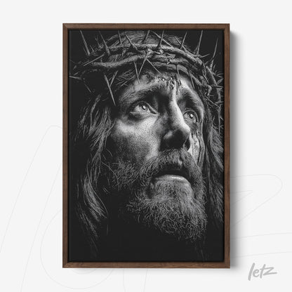 framed wall art in dark wooden frame featuring a black and white portrait of a religious figure wearing a crown of thorns