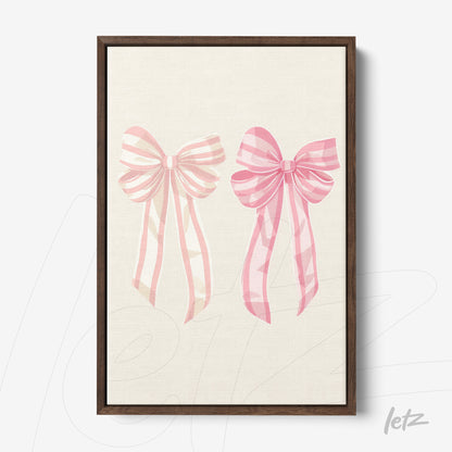 framed artwork featuring pink bows on a light background with dark wooden frame