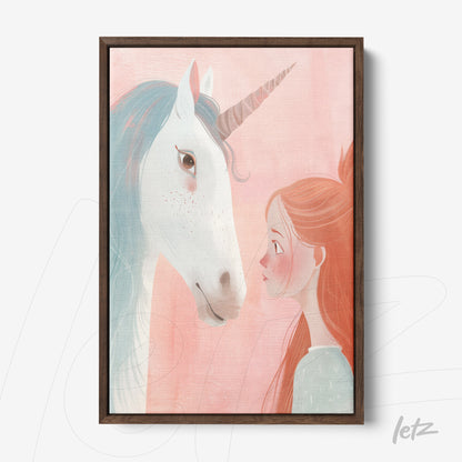 framed decorative art featuring a girl gazing at a unicorn on a soft pink background with a dark wooden frame